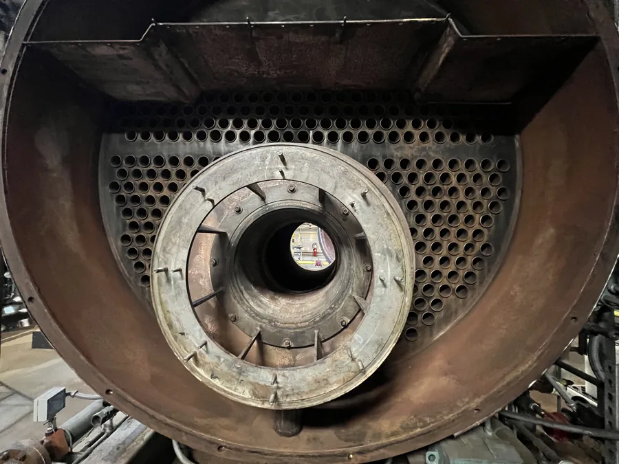 Boiler tube bundle and burner throat exposed for cleaning during NYC boiler maintenance