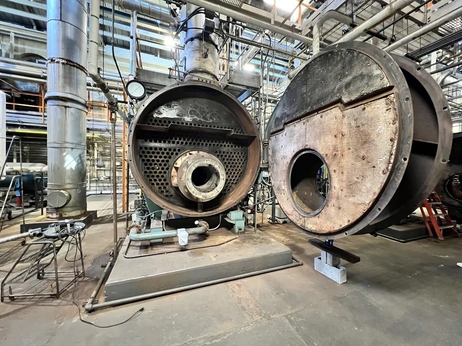 Industrial boiler with rear doors swung open for annual inspection in New York City