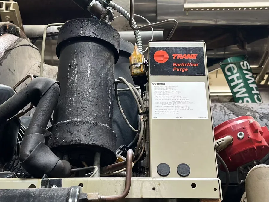Chiller purge unit inspected during preventive maintenance in a NYC plant room