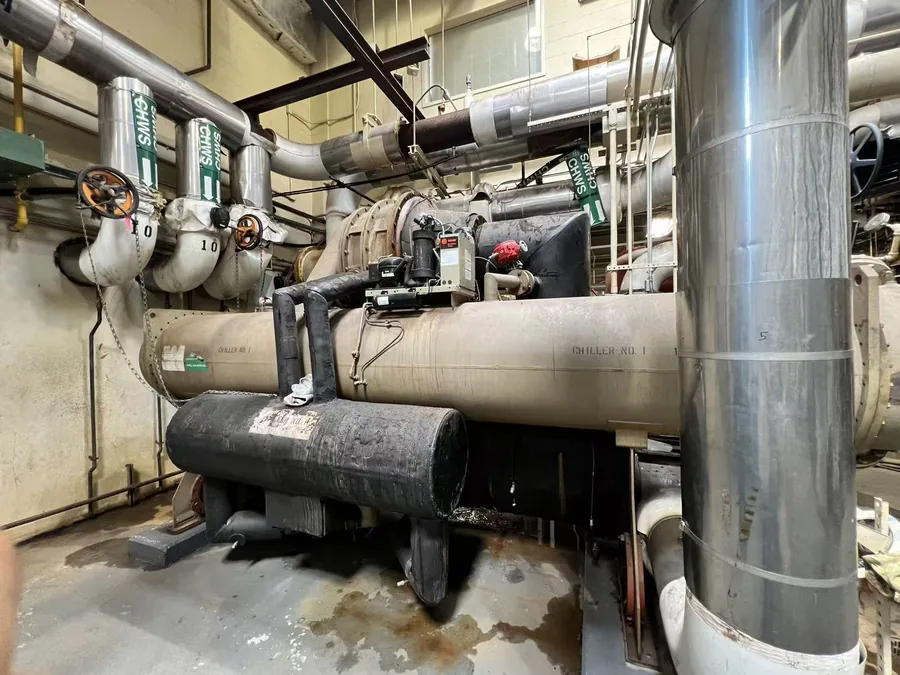 Water-cooled chiller and chilled water supply piping in a NYC mechanical room